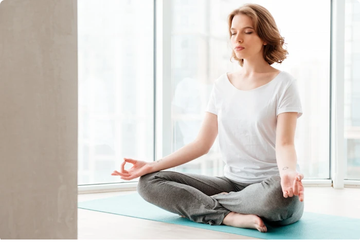 lady folding legs in yoga position